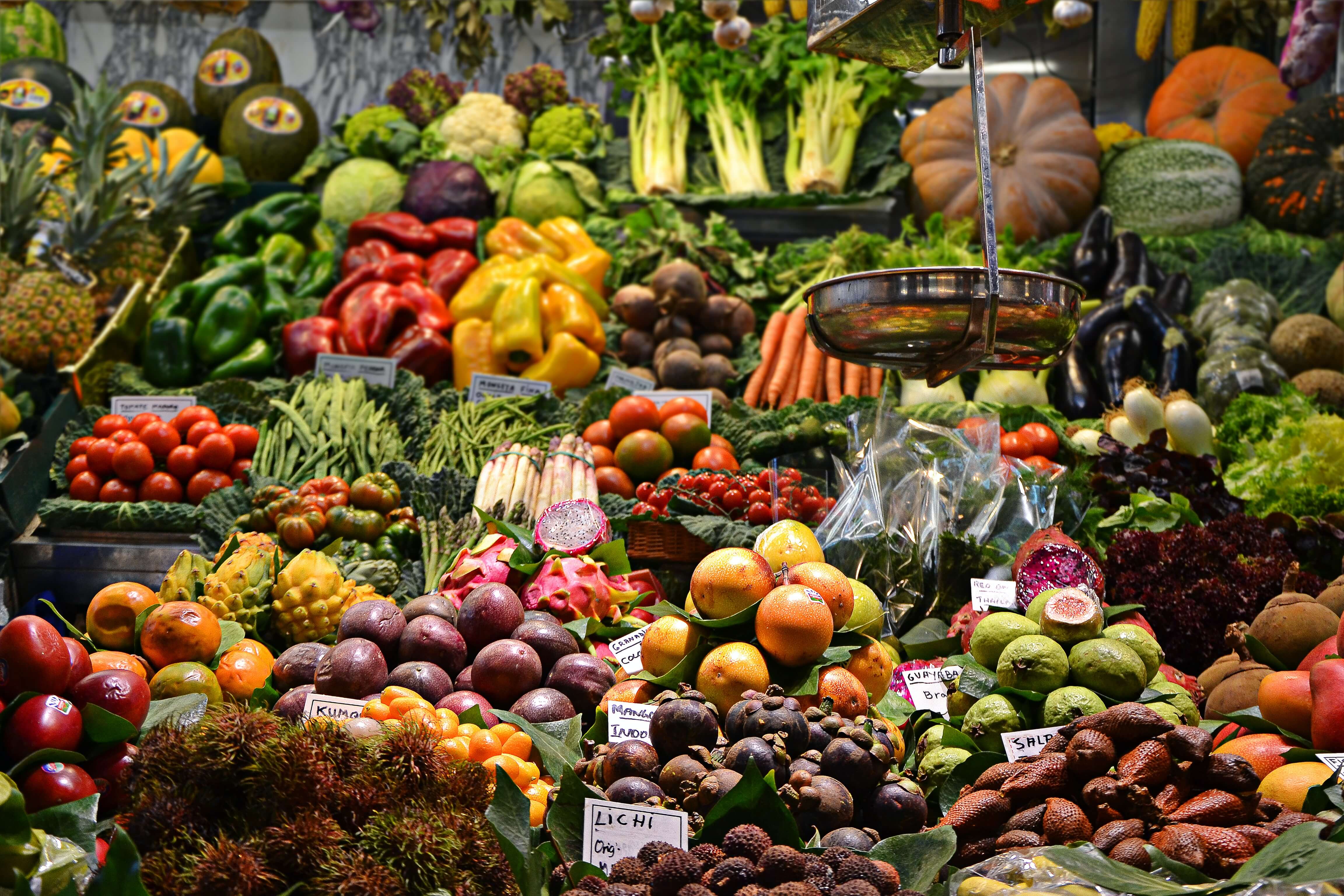 A image of a lot of fruit at a market stall.